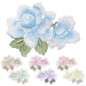 May include: Assortment of embroidered flower patches in various colors, including blue, pink, green, purple, and yellow. The patches feature delicate floral designs with intricate details.