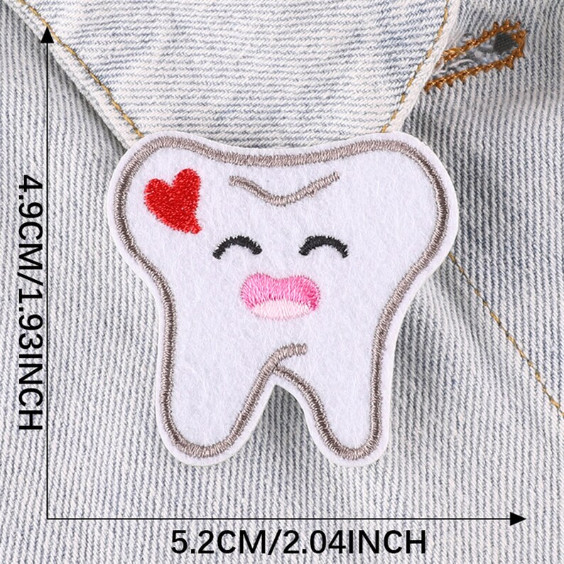 May include: White embroidered tooth with a red heart and pink lips. The tooth is 4.9 inches tall and 5.2 inches wide.