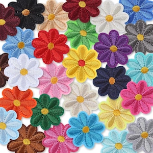 May include: A selection of embroidered daisy flower patches in a variety of colours, such as black, red, white, blue, green, yellow, and pink. Each flower has a yellow centre. These patches are suitable for fabric crafts and embellishments.