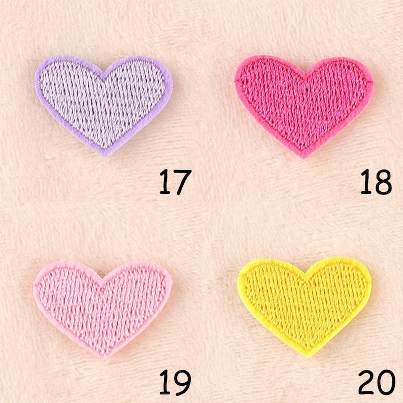 May include: Four heart-shaped fabric patches in different colors: purple, pink, light pink, and yellow. The patches are numbered 17, 18, 19, and 20.