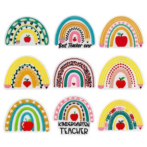 May include: Nine colourful rainbow patches with various designs, each featuring a red apple. Some patches include text like "Best Teacher ever" and "Kindergarten Teacher". The patches are embroidered with bright colours and are on a white background.