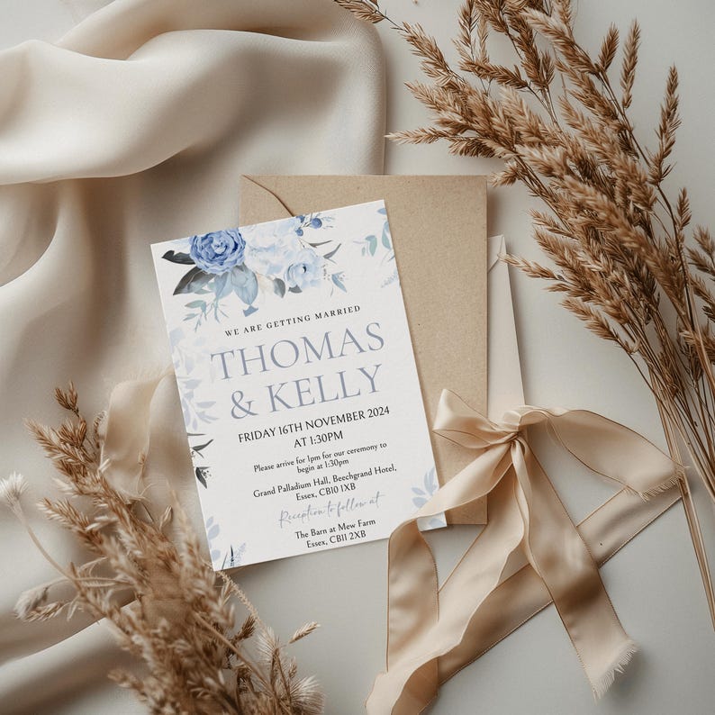 May include: A wedding invitation with blue floral designs. The invitation reads "We are getting married, Thomas & Kelly, Friday 16th November 2024 at 1:30pm. Please arrive for 1:30pm for our ceremony to begin at 1:30pm. Grand Palladium Hall, Beechgrand Hotel, Essex, CB10 1XB. Reception to follow at The Barn at Mew Farm, Essex, CB11 2XB."