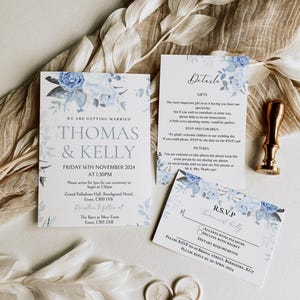 May include: A wedding invitation with blue floral designs. The invitation reads "We are getting married, Thomas & Kelly, Friday 16th November 2024 at 1:30pm". The invitation includes the ceremony and reception locations.