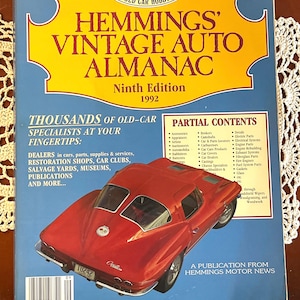 May include: The cover of the Hemmings Vintage Auto Almanac 1992, Ninth Edition, features a red classic car. The magazine's title is in large, bold letters with a yellow banner. The cover also includes a list of contents and the text "Thousands of Old-Car Specialists".
