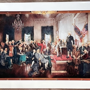 May include: A framed print of a historical painting depicting a gathering of men in a large room. The artwork features a chandelier, flags, and a central figure standing on a raised platform. The color palette includes browns, reds, and blues.