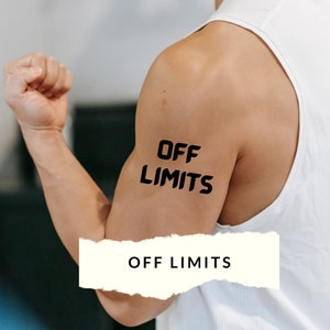 May include: A person's arm flexed, with the words "OFF LIMITS" tattooed in black on the bicep. The person is wearing a white tank top. A rectangular banner at the bottom of the image also displays the words "OFF LIMITS".