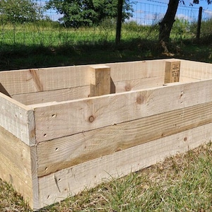 May include: A wooden raised garden bed made from untreated planks. The bed is rectangular and has a natural wood colour.