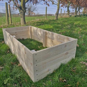 May include: An untreated pine raised garden bed, ready for planting. The bed is made of wooden planks.
