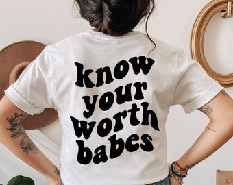 May include: White t-shirt with black text that reads "know your worth babes".