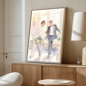 May include: Watercolor painting of a wedding couple holding hands, walking down stairs. The bride wears a white dress and carries a bouquet. The groom is in a dark suit. The artwork is framed in a light wood frame.