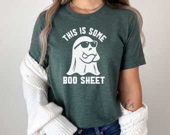 May include: A green t-shirt with a white ghost wearing sunglasses and the text "This is some boo sheet".