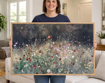 May include: A framed artwork featuring a field of wildflowers in shades of red, pink, yellow, and white. The painting has a dark, moody background and is encased in a light brown wooden frame.