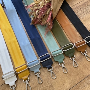 Peut inclure: Assortiment de 10 sangles tissées colorées avec des fermoirs pivotants argentés. Les sangles sont de différentes couleurs, notamment blanc, jaune, bleu clair, bleu marine, vert clair, vert olive, marron et beige.