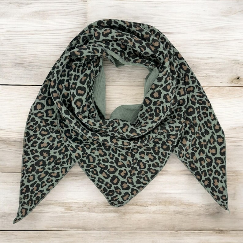 May include: A green triangular scarf with a brown leopard print pattern.
