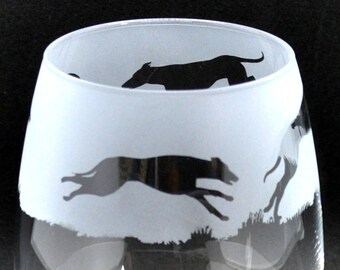 Könnte beinhalten: Ein gefrostetes Weinglas aus Glas mit einer Silhouette von drei Windhunden, die rennen. Das Glas hat einen klaren Boden und die Worte "G. De La Soul" sind auf dem Boden sichtbar.