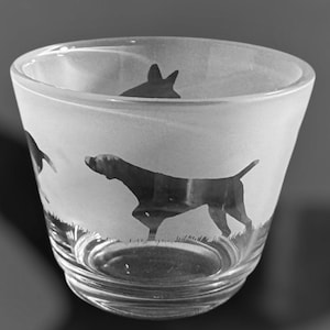 May include: A frosted glass tumbler with a silhouette of a dog etched on the side. The dog is in a running position with its tail raised.