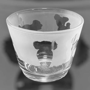 May include: A clear glass tumbler with a frosted white band featuring etched koala bear designs. The glass has a wide mouth and a slightly tapered shape, suitable for beverages. The koala designs are in silhouette.