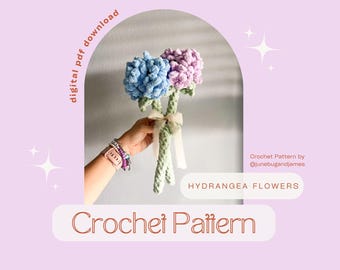 May include: A crochet pattern for hydrangea flowers. The image shows a bouquet of handmade flowers in shades of blue and purple, tied with a white ribbon. The text on the image says "Crochet Pattern" and "Hydrangea Flowers".