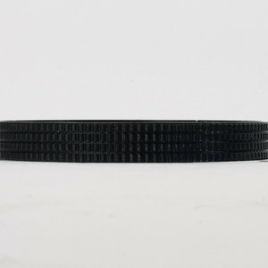 May include: A black rubber ring with a textured surface.