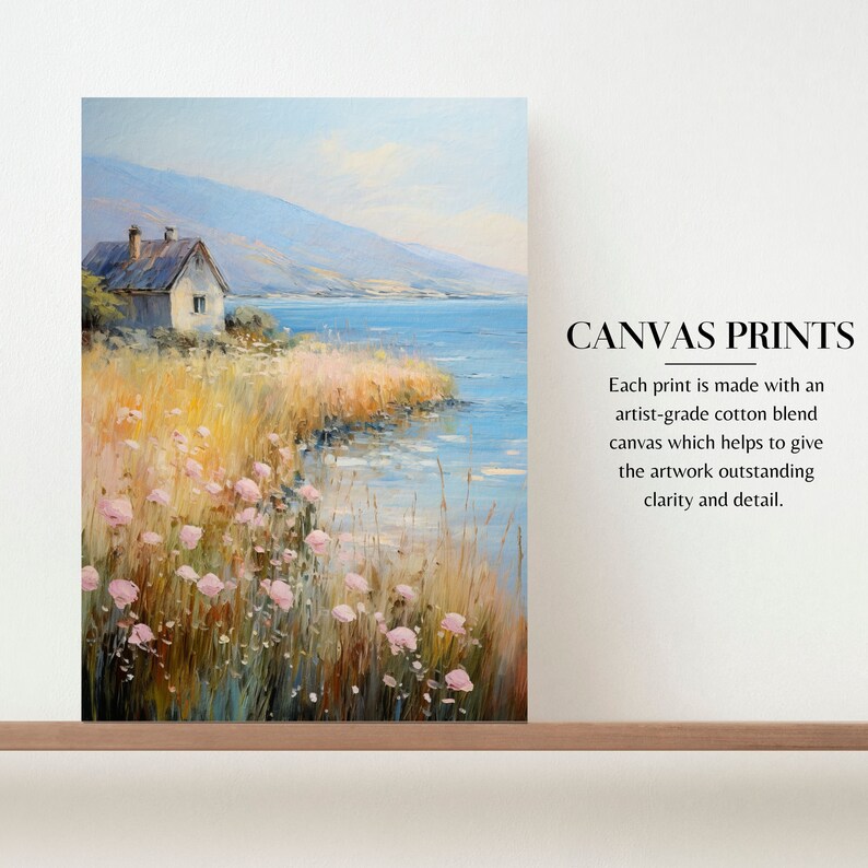 a painting of a house by the water on a shelf