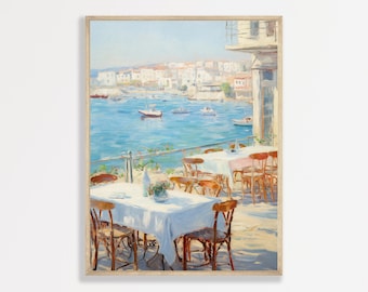 May include: A painting of a seaside cafe with white tables and chairs, overlooking a blue ocean with boats. The cafe is located in a town with white buildings.