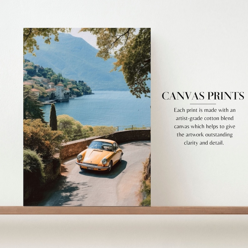 a yellow car driving down a road next to a lake