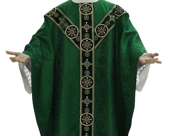 May include: Green liturgical vestment with gold and black embroidery. The vestment features a V-shaped neckline and a decorative pattern of circles and crosses.