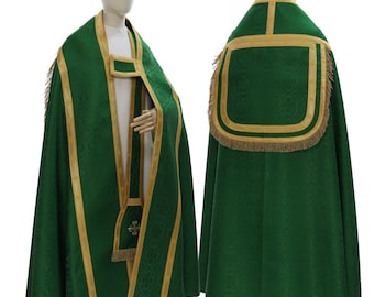 May include: A green liturgical cope with gold trim and a gold fringe. The cope is worn over a white alb and a stole.