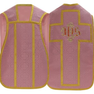May include: Pink liturgical vestment with gold trim and a cross embroidered with the letters "IHS" in red and gold.