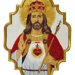 May include: Embroidered patch featuring a depiction of Jesus Christ as King of Kings. He is wearing a gold crown, a red robe, and a white tunic. He holds a scepter in his right hand and his left hand is raised in blessing. His heart is visible through his tunic, with a crown of thorns and flames. The patch is surrounded by a gold frame.