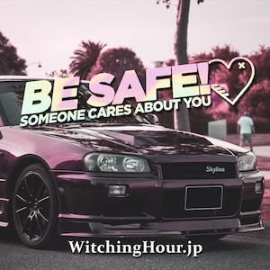 May include: A purple car with a "BE SAFE! SOMEONE CARES ABOUT YOU" message and a heart graphic. The car is a Nissan Skyline with the word "Skyline" on the front grill. The car is parked on a street with a person walking in the background. The text "WitchingHour.jp" is at the bottom of the image.