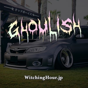 May include: A black Subaru with a custom "GHOULISH" decal in dripping pastel colours. The text "WitchingHour.jp" is below the car.
