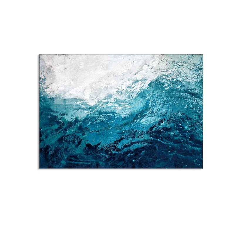 May include: Abstract art print featuring a close-up of a blue wave with white foam. The image has a textured, watery look.