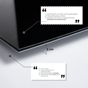 May include: A black glass whiteboard with rounded edges. The board is 2 cm thick and stands 2 cm off the ground. The board is wipeable and can be printed on with a UV digital printer. The text on the board reads: "Certificated, number one quality glass, Wipeable glass surface, Direct print with UV Digital Printer (Printing is on the back side.)"