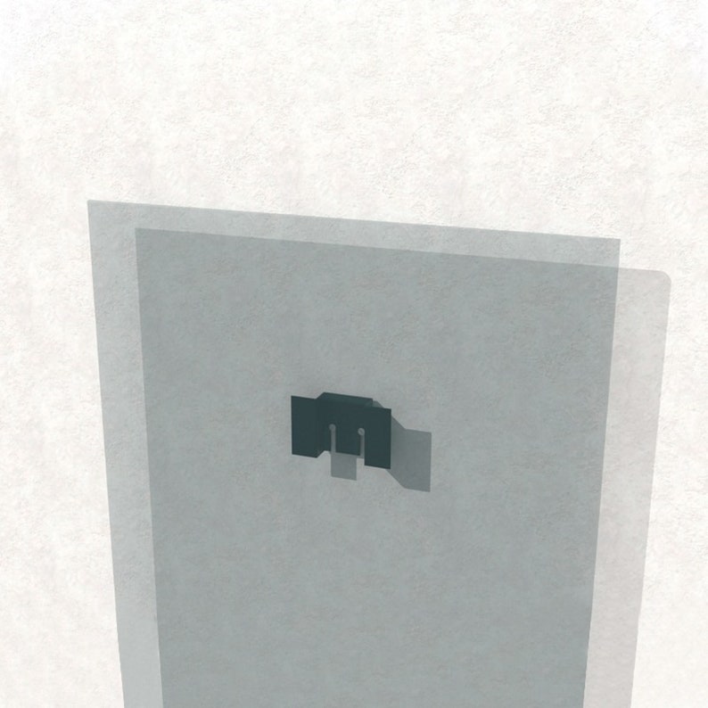 May include: A close-up of a black metal wall mount bracket. The bracket is attached to a white wall and is partially obscured by a clear glass panel.