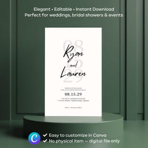 Op de afbeelding: Een witte trouwkaart met zwarte scripttekst met de tekst "Ryan and Lauren" en de datum "08.15.29". De uitnodiging bevat de evenementdetails en is eenvoudig aan te passen in Canva.