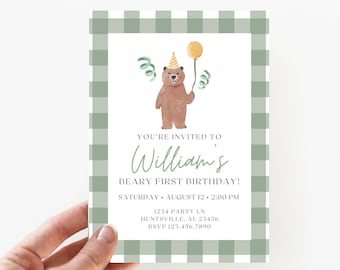 May include: A green and white checkered invitation card with a cartoon bear wearing a party hat and holding a yellow balloon. The text on the card reads "You're invited to William's Beary First Birthday! Saturday, August 12, 2:00 PM 1234 Party Ln Huntsville, AL 23456 RSVP 123.456.7890"