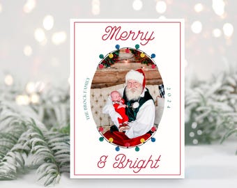 May include: A Christmas card featuring a photo of Santa Claus holding a baby in a red and white outfit. The photo is surrounded by a circle of colorful lights and the text "Merry & Bright" is written below the photo. The text "The Brock Family" is written on the left side of the card and the year "2024" is written on the right side of the card.