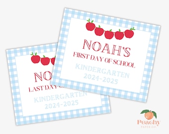May include: Two blue and white gingham patterned signs with red apple illustrations and text. The top sign says "Noah's First Day of School Kindergarten 2024-2025". The bottom sign says "Noah's Last Day of School Kindergarten 2024-2025".