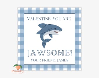 May include: A blue and white gingham patterned card with a cartoon shark and the text "VALENTINE, YOU ARE JAWSOME! YOUR FRIEND, JAMES".
