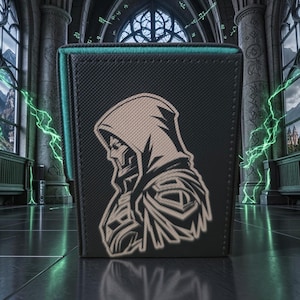 May include: A black rectangular wallet featuring a textured surface and a light-colored graphic illustration of a hooded figure in profile. The wallet has stitched edges and a dark, sleek finish, showcasing a detailed depiction of a cloaked character.