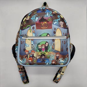 May include: A mini backpack featuring a colorful illustration of a fantasy scene with characters and objects. The backpack has a front zippered pocket and adjustable straps. The design includes a Hogwarts crest and various magical elements.