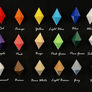 May include: A collection of 18 diamond-shaped plastic ornaments in various colours, including red, orange, yellow, light blue, blue, white, purple, pink, beige, peak green, pine green, silk white, transparent, brown, bone white, light brown, grey, and black.