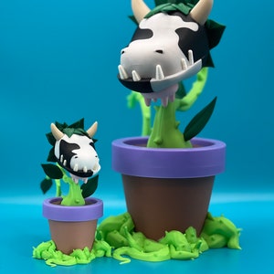 May include: Two potted cow-like plants with green leaves and purple pots. The larger plant has a white and black cow pattern on its head and a green leafy crown. The smaller plant is similar but smaller in size.