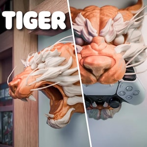 May include: A detailed, orange and white tiger head sculpture with a white PlayStation 5 controller. The word "TIGER" is displayed in white block letters. The tiger head has intricate details and is mounted on a wall.