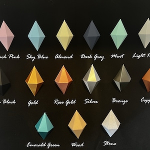 May include: A chart of 15 different coloured diamond-shaped ornaments. The colours include peach pink, sky blue, almond, dark grey, mint, light khaki, deep black, gold, rose gold, silver, bronze, copper, emerald green, wood, and stone.