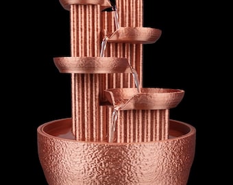May include: A copper tabletop fountain with four tiers of cascading water. The fountain has a textured, hammered finish and a round base.