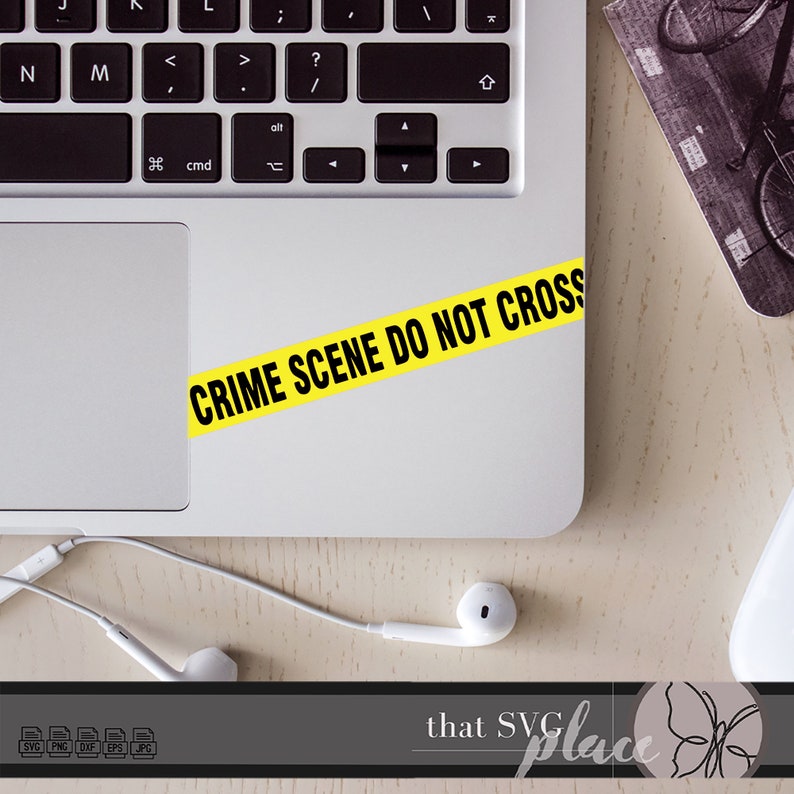 May include: A yellow and black crime scene do not cross tape sticker on a silver laptop.