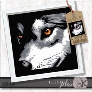 May include: A framed artwork featuring a detailed illustration of a wolf's face. The wolf's fur is rendered in shades of gray and white, with striking orange eyes. The artwork is framed in a white square frame. A tag reads "3D WOLF 3D SHADOW BOX".