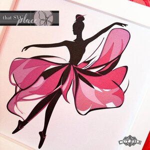 May include: A black silhouette of a ballerina with a pink and white layered tutu, dancing in mid-air. The background is white.